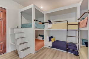 Unfurnished bedroom featuring wood finished floors