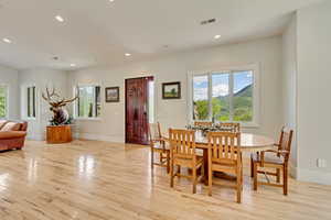 Dining area with light wood-style floors, recessed lighting, and baseboards
