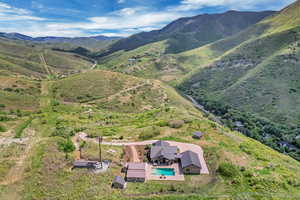 View from above of property with a pool and a mountainous background