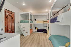 Bedroom with wood finished floors and recessed lighting