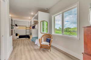 Living area featuring wood finished floors, baseboards, and recessed lighting