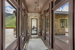 Doorway to outside with french doors, wooden ceiling, dark wood-type flooring, and a mountain view