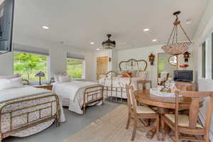 Bedroom featuring finished concrete floors and recessed lighting