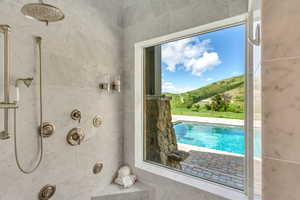 Full bath with tiled shower and a mountain view