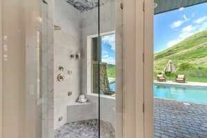 Full bath featuring a tile shower and a mountain view