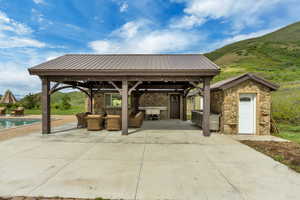 View of patio with a gazebo, an outdoor living space, an outdoor pool, and a mountain view