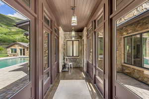Doorway to outside featuring wooden ceiling, dark wood-style floors, and french doors