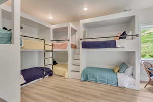 Bedroom with wood finished floors and recessed lighting