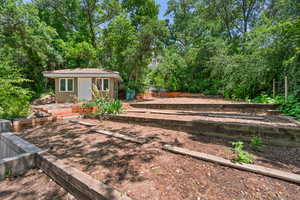 View of yard featuring an outbuilding on upper back of property.