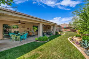 View of yard featuring ceiling fan and a patio area