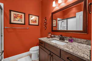Bathroom with vanity, tile patterned floors, and a shower with shower door