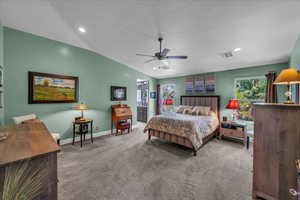 Bedroom featuring lofted ceiling, carpet flooring, recessed lighting, a textured ceiling, and ensuite bathroom