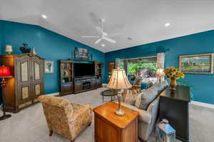 Living area with carpet floors, lofted ceiling, a ceiling fan, and recessed lighting