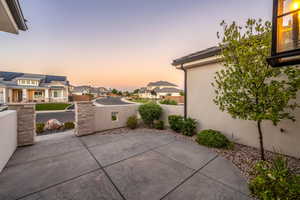 Patio terrace at dusk featuring a residential view and a patio area