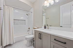 Full bath featuring vanity and shower / bathtub combination with curtain