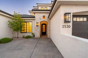 Entrance to property featuring stucco siding and stone siding