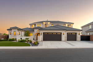 Prairie-style house featuring stone siding, a garage, concrete driveway, and stucco siding