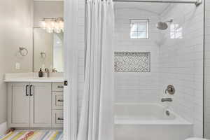 Full bathroom featuring shower / tub combo with curtain and vanity