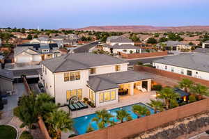 Back of property with a fenced backyard, a residential view, stucco siding, a tile roof, and a mountain view