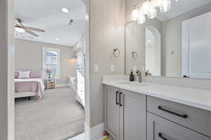Bathroom with vanity, ceiling fan, connected bathroom, and recessed lighting