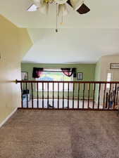 Corridor featuring carpet floors and baseboards