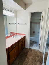Full bath with vanity and tile patterned floors