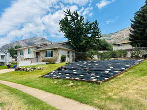 View of front of house with stone siding and a mountain view