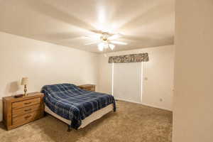Bedroom featuring light colored carpet and ceiling fan