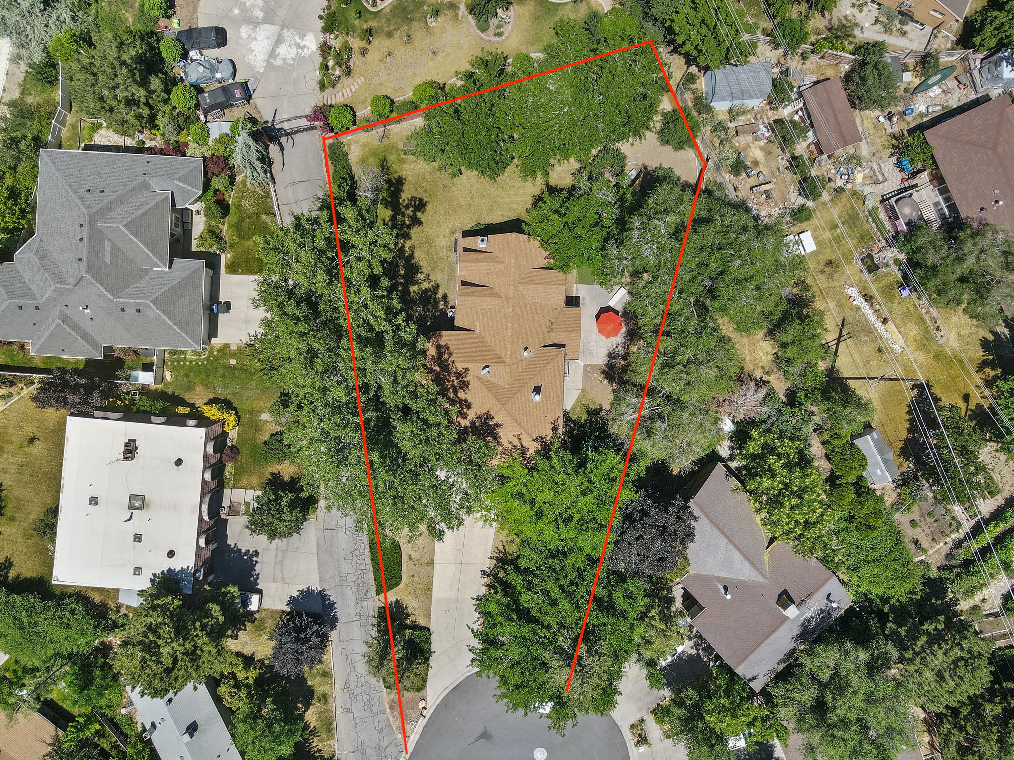 Aerial view of property and surrounding area featuring property parcel outlined