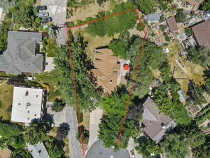 Aerial view of property and surrounding area featuring property parcel outlined