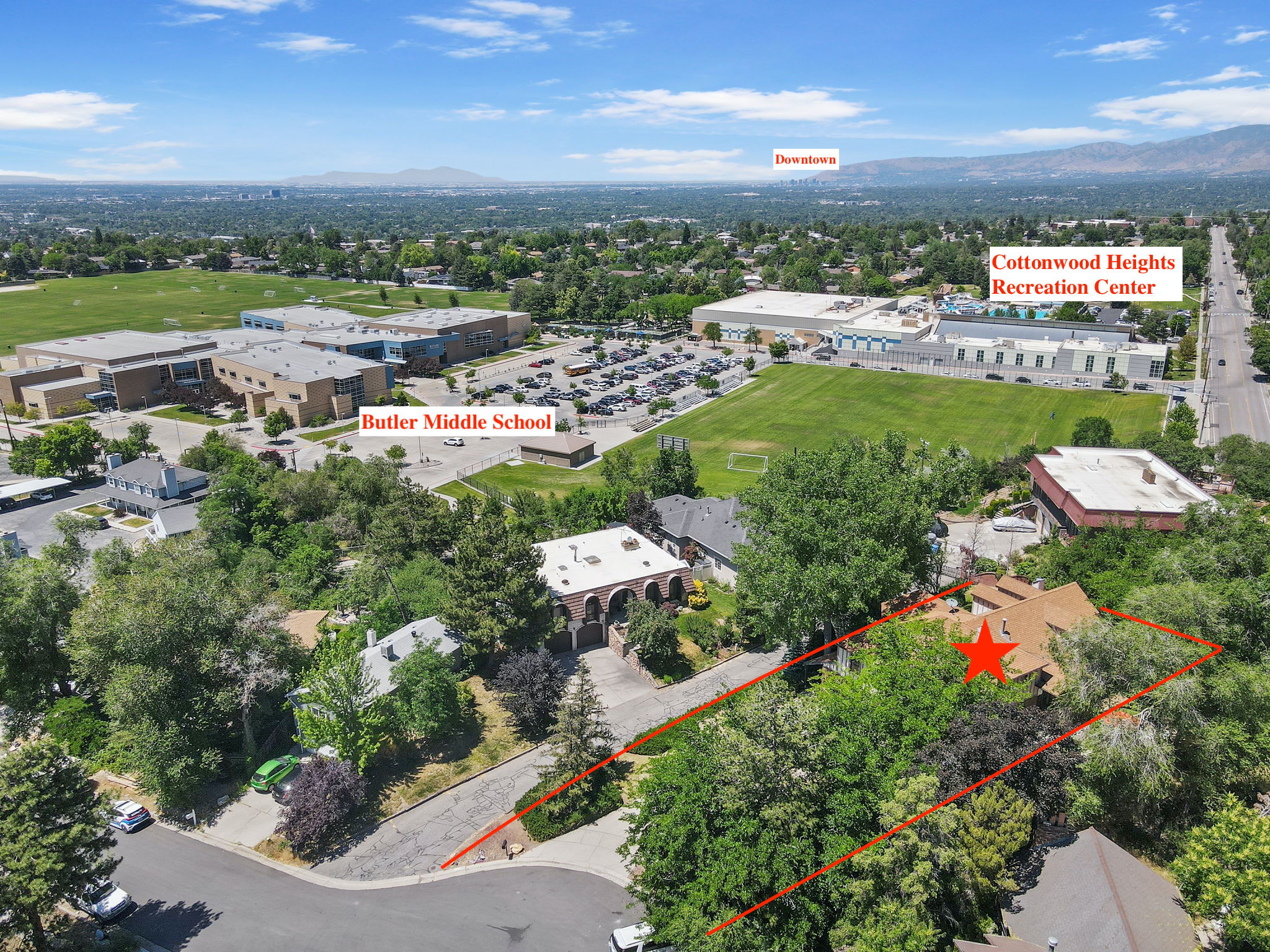 Aerial overview of property's location with property boundaries highlighted and a mountainous background
