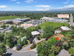 Aerial overview of property's location with property boundaries highlighted and a mountainous background