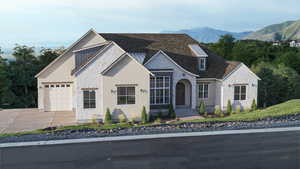 View of front of home with stone siding, a garage, driveway, and a mountain view