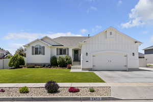 Ranch-style house featuring board and batten siding, a garage, concrete driveway, brick siding, and a shingled roof