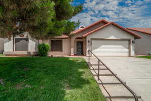 Mediterranean / spanish-style house featuring concrete driveway, a garage, stucco siding, a front yard, and a tile roof