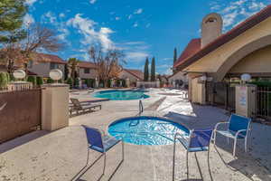 Community pool with a patio and a residential view