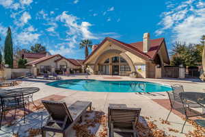Community pool with a patio