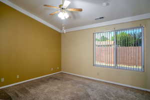 Carpeted empty room featuring ceiling fan, baseboards, and a smoke detector