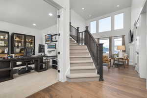 Staircase featuring hardwood / wood-style floors and recessed lighting