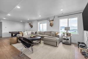 Living area with hardwood / wood-style flooring, pool table, and recessed lighting