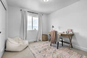 Carpeted office space featuring baseboards