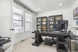 Office with carpet flooring and recessed lighting