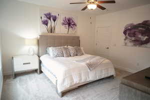 Carpeted bedroom featuring baseboards and a ceiling fan