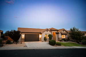 Mediterranean / spanish home with stone siding, stucco siding, and a tiled roof