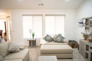 Living area with light colored carpet