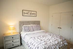 Bedroom featuring carpet floors and a closet