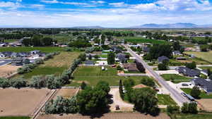 Aerial overview of property's location featuring nearby suburban area and mountains