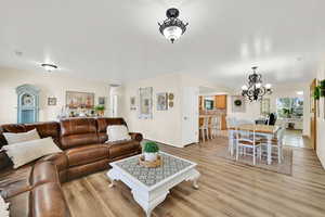 Living room with a chandelier and light wood-style floors