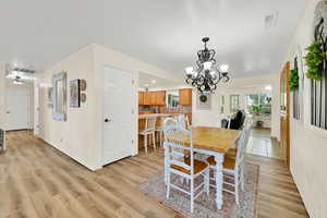 Dining room with a chandelier and light wood finished floors