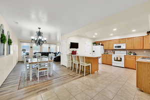 Dining space with a chandelier, recessed lighting, and light tile patterned floors